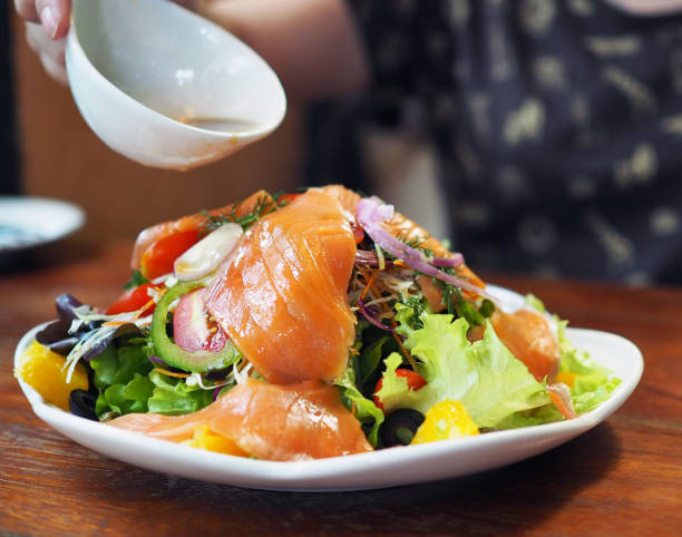 istock Pour over balsamic vinegar over sashimi salad; fresh sliced of salmon with fresh mixed vegetable. 941724332