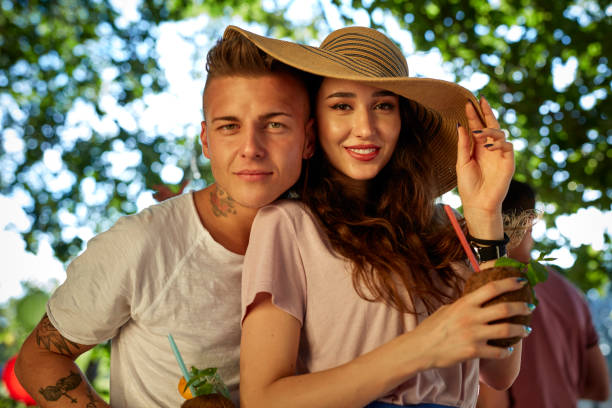 istock Garden party. Young people flirting and looking at camera 941727126
