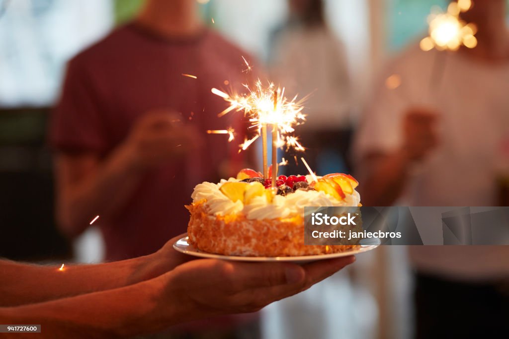 Celebrating birthday. Summer garden party Young woman enjoying her birthday surprise Birthday Stock Photo