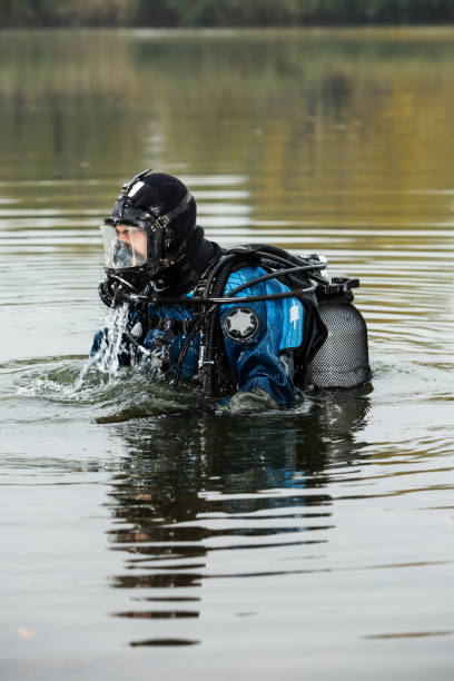 istock A male scuba diver comes from under the water climbs back on coast 941728422