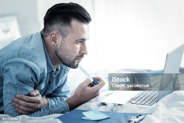 Serious Smart Man Holding A Pen Stock Photo - Download Image Now - Internet, Learning, Small Business