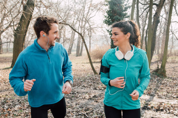 istock Smiling young athletic couple running 941730492