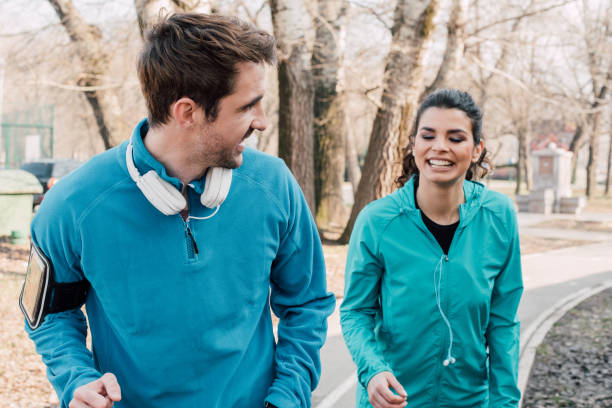 istock Happy athletic couple jogging in a park 941731772