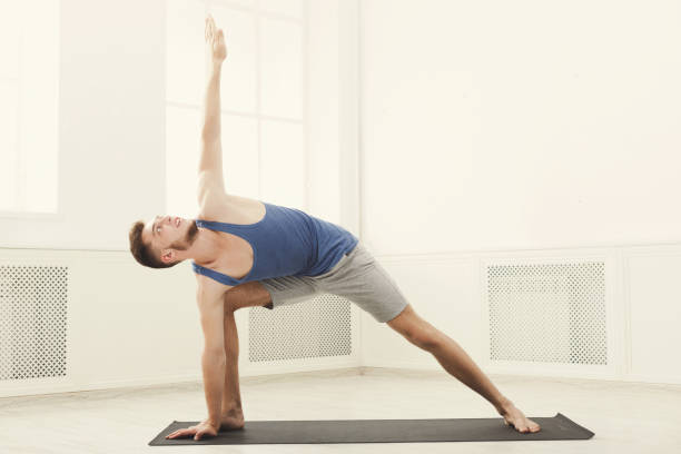 istock Man stretching at white background indoors 941731942