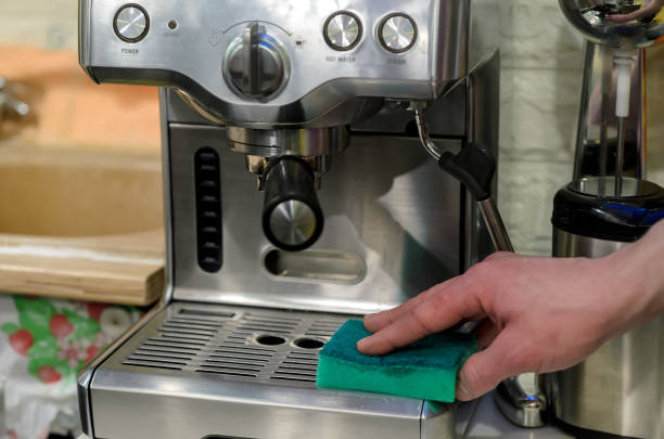 istock Barista cleaning coffee machine at cafe 941733252