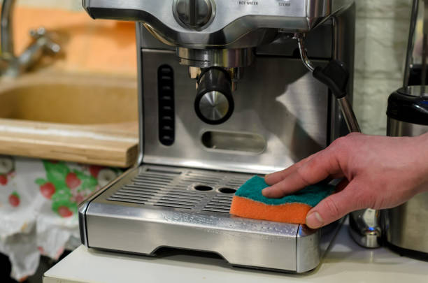 istock Barista cleaning coffee machine at cafe 941736624