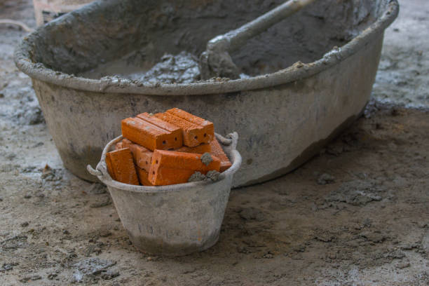 istock Red brick in plastic bucket on construction wall site 941737518