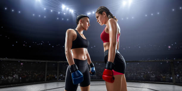 Muscular female Mixed Martial Arts athletes in professional ring