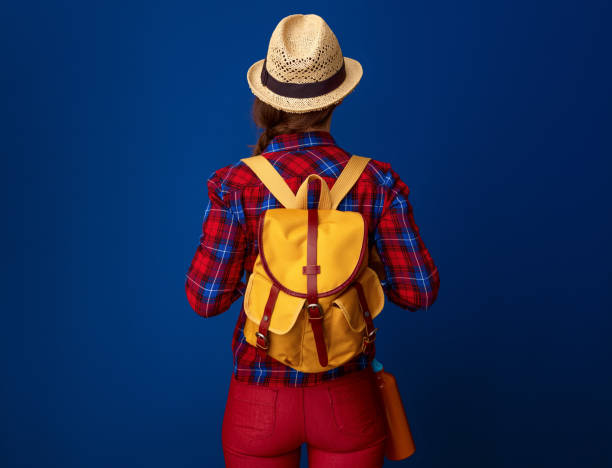 istock active tourist woman with backpack isolated on blue 941737742
