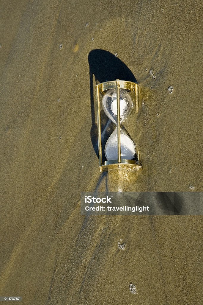 Hourglass Sand Timer Overwhelmed By Rising Tide  Beach Stock Photo
