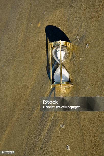 Hourglass Sand Timer Overwhelmed By Rising Tide Stock Photo - Download Image Now - Beach, Beat The Clock, Breaking Wave