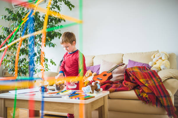 istock Cute boy playing at home 941737872