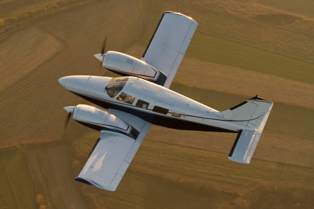 Private plane flying over the fields stock photo