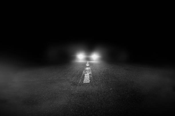 la solitaria carretera por la noche con el coche en marcha. - driving night car headlight fotografías e imágenes de stock