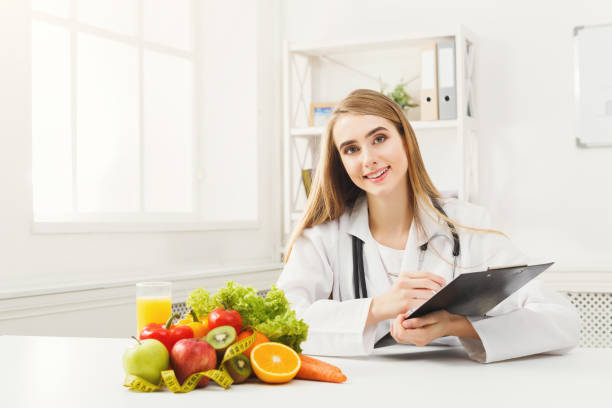 istock Nutritionist desk with fruit and measuring tape 941746766