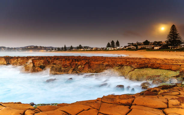 Daybreak Seascape with Full Moon Capturing the sunrise from North Avoca Beach on the Central Coast, NSW, Australia. avoca beach photos stock pictures, royalty-free photos & images