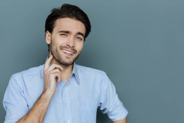 istock Positive cheerful man touching his beard 941757040