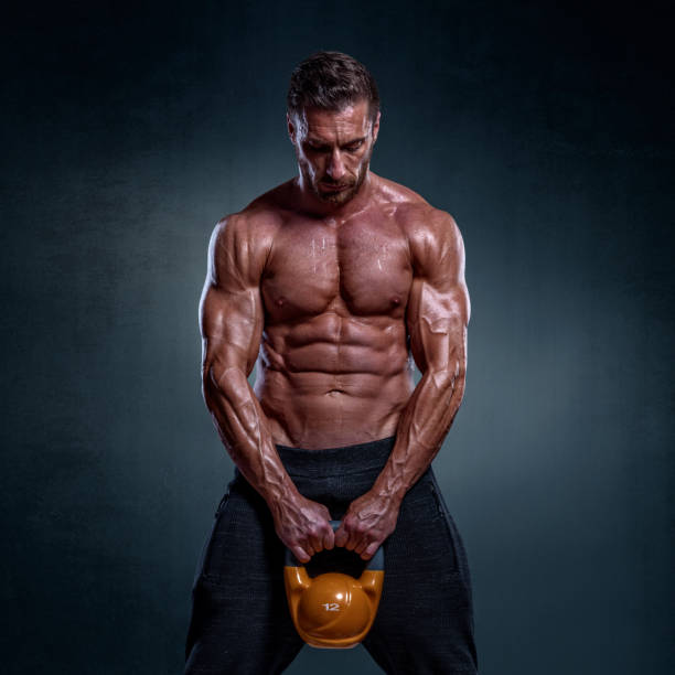 istock Male fitness athele with kettlebell 941757230