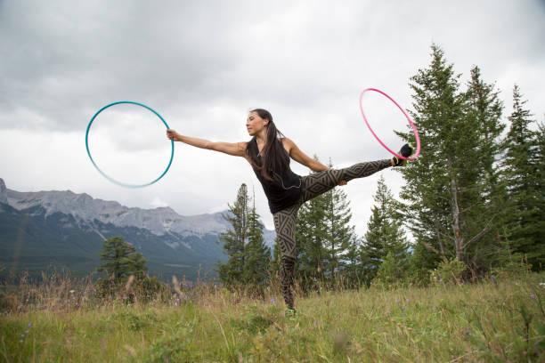 istock Native American woman dances with hoops, in mountains 941757654