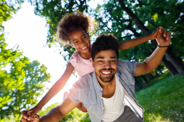 istock Smiling father giving his daughter piggyback ride 941758724