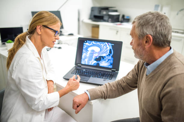 istock Doctor explaining brain x-ray to patient 941762270