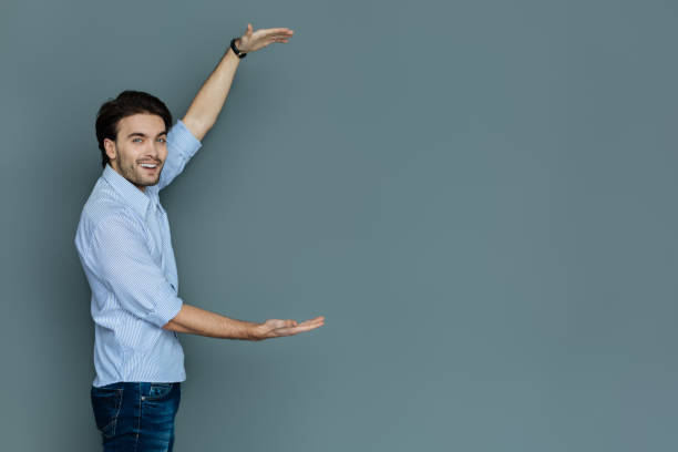 istock Delighted positive man showing the size of an object 941765730
