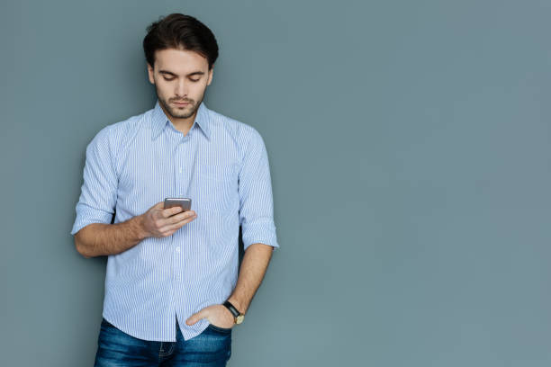 istock Smart serious man putting hand in his pocket 941766130