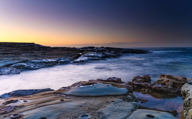 istock Rocky Sunrise Seascape 941766234