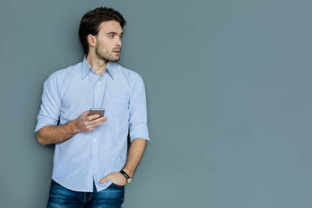 istock Smart nice man holding his smartphone 941766244