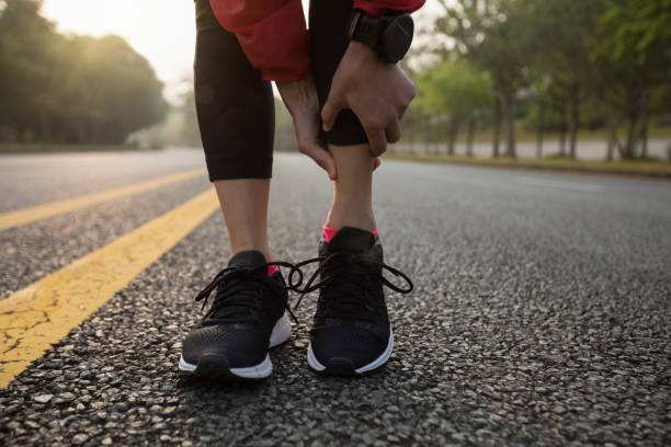 istock female runner touching sport injured calf 941766538