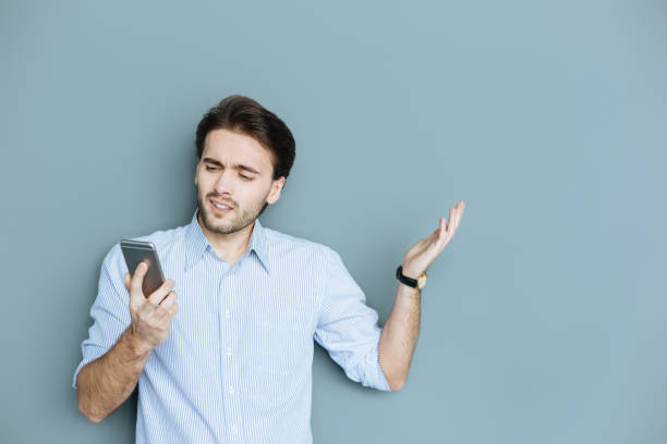 istock Nice confused man looking at the smartphone screen 941766564