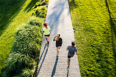 Young athtletes in the city running in park.