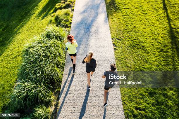 Young Athtletes In The City Running In Park Stock Photo - Download Image Now - Running, Public Park, City