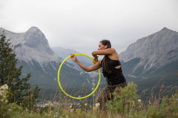 istock Native American woman dances with hoops, in mountains 941770350