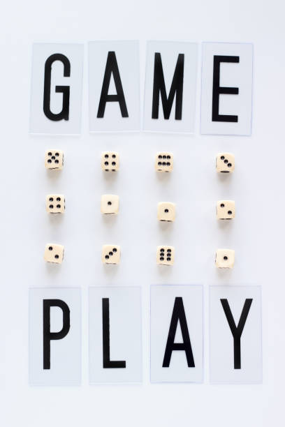 istock GAME PLAY words and gaming dice in row on white background. 941775088