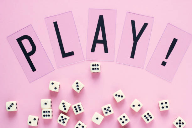 istock Gaming dice with word PLAY on pink background. 941775092