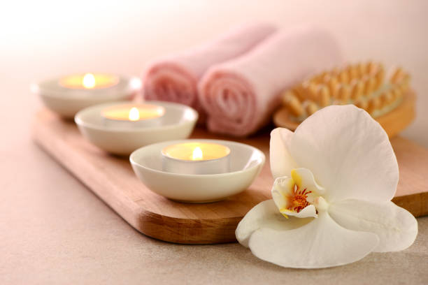 istock Spa concept with burning aromatic candles and white orchid 941775998
