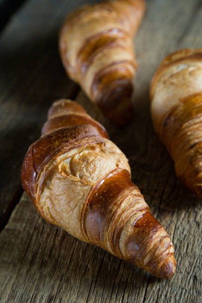 istock Fresh croissants on a wooden table 941776036