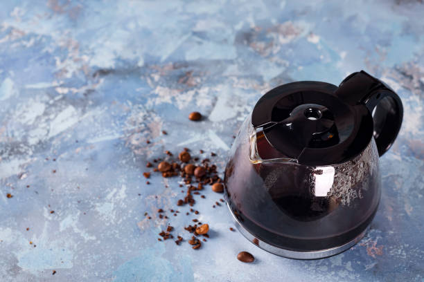 Coffee maker pot filling with coffee beans