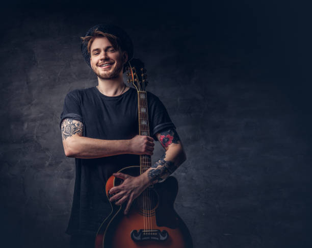 Portrait of smiling young man playing the guitar