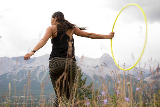 istock Native American woman dances with hoops, in mountains 941778542