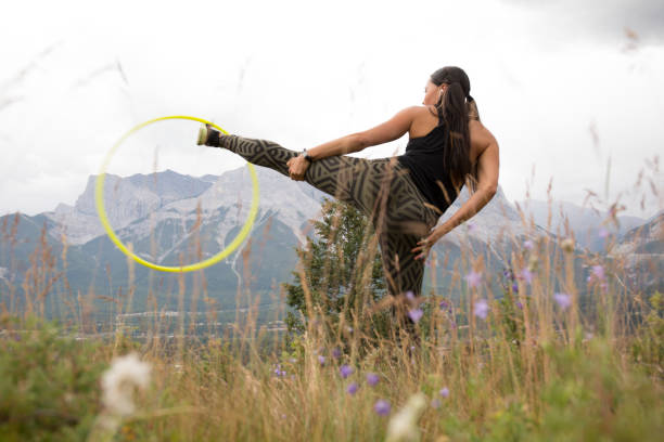 istock Native American woman dances with hoops, in mountains 941778548