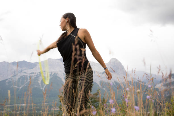 istock Native American woman dances with hoops, in mountains 941778626