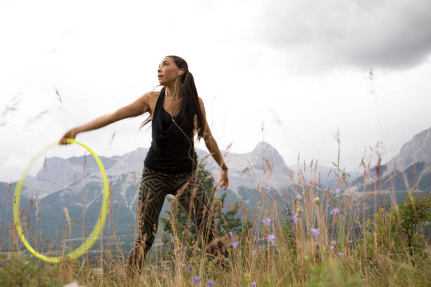 istock Native American woman dances with hoops, in mountains 941778772