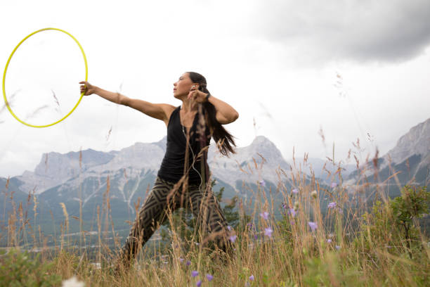 istock Native American woman dances with hoops, in mountains 941778774