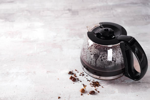 Coffee maker pot filling with coffee beans