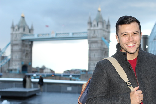 Foreigner smiling around Tower Bridge (London).