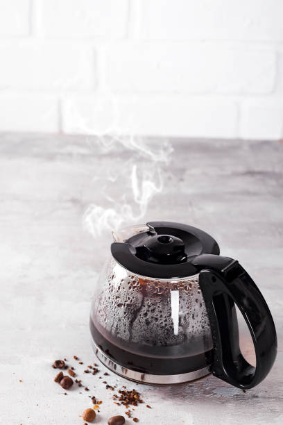 Coffee maker pot filling with coffee beans