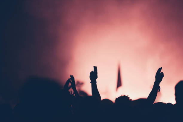 istock Crowd at concert with raised arms 941781648