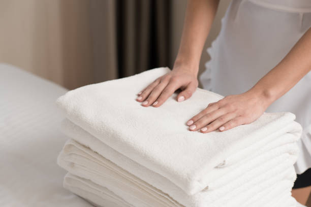 istock young beautiful maid in uniform with stack of clean towels 941785636